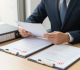 Land value-added tax and urban renewal property legal documents on desk