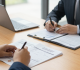 Payroll tax compliance and employment documents in an HR legal meeting